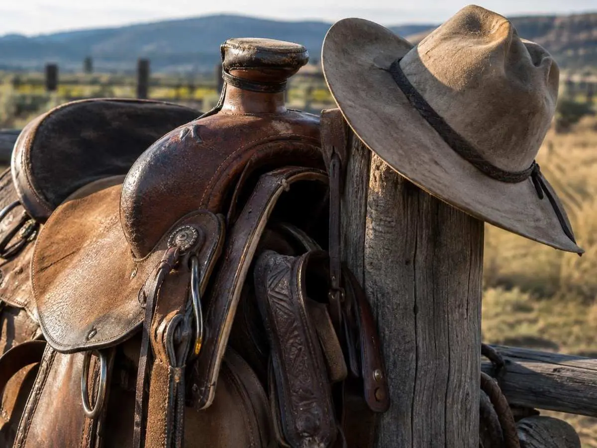 Saddle and hat on the fence post Saddle and hat on the fence post